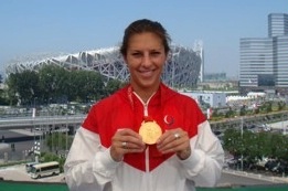 Olympian Carli Lloyd show off her gold medal from the 2008 Beijing Olympics